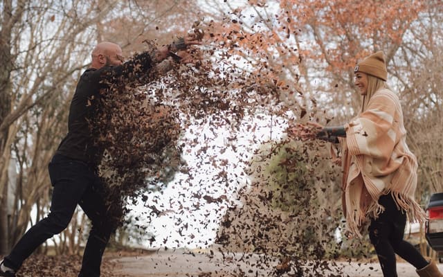 Cass and Kathryn Morrow playing in autumn leaves