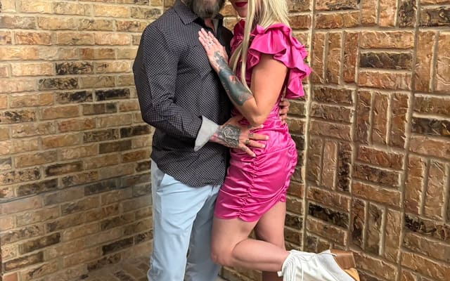 Cass and Kathryn Morrow dressed sharp against a brick wall