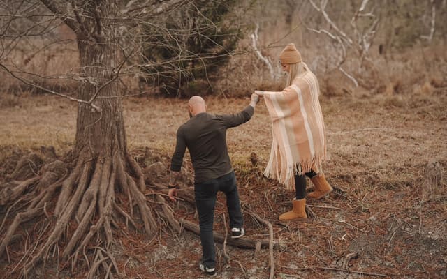Cass helping Kathryn walk in nature