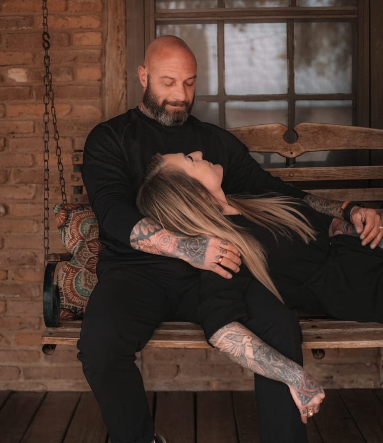 Kathryn Morrow relaxing on a porch swing with her head on Cass's lap